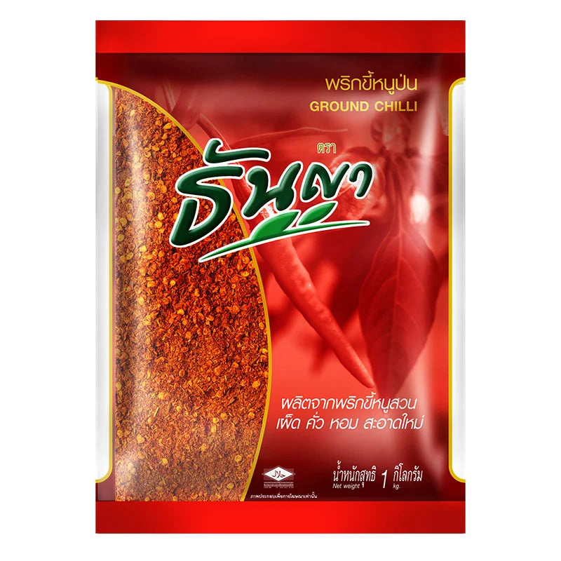 Ground chili spice from Thai Thanya in a 1 kg package, showcasing vibrant red chili powder in a clear container.