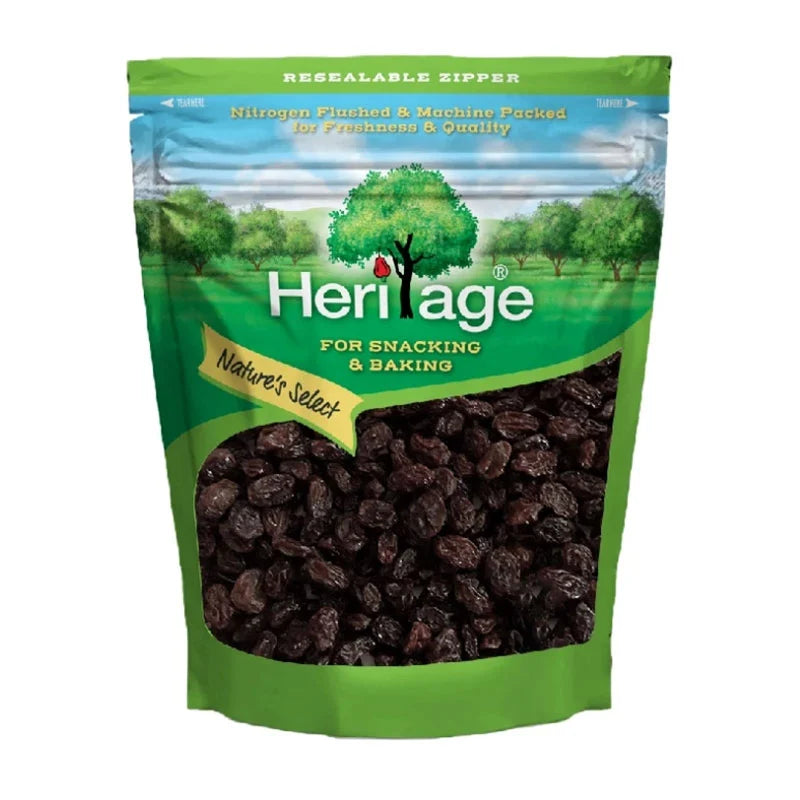 HERITAGE Black Raisins in a 1 kg package, showcasing plump, dark dried grapes ready for snacking or cooking.