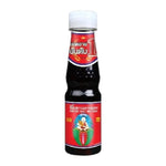 Deksomboon Thin Soy Sauce 140ml bottle, clear label, placed on a kitchen countertop, suitable for Asian cuisine cooking.