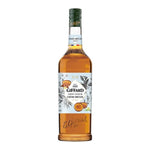 Giffard Barista Creme Brulee 1L bottle, a dry grocery flavoring for coffee and desserts, with a clear label and golden liquid inside.