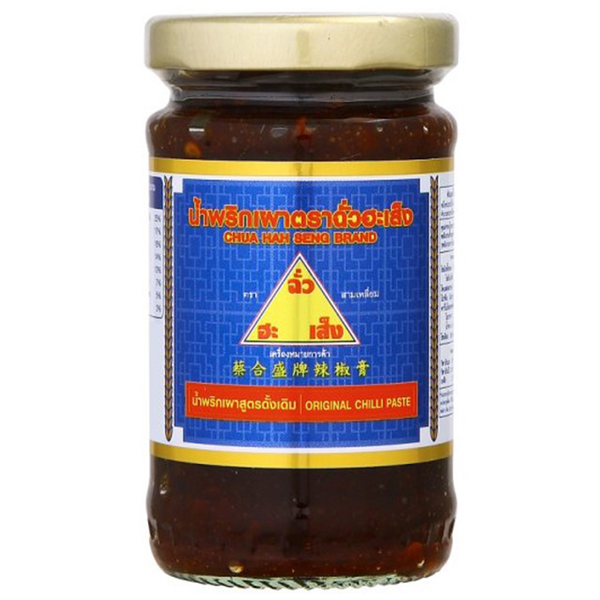 Jar of Chua Hah Seng Thai Chili Paste showing red chili ingredients and the label in a grocery setting
