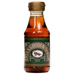 Tate & Lyle Golden Syrup pouring from a glass jar, showcasing thick, amber syrup ideal for cooking and baking.