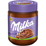 Creamy Milka Hazelnut Spread jar with chocolate and hazelnut ingredients visible, showcasing the delicious treat.