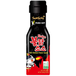 Samyang Buldak Hot Chicken Sauce bottle, spicy Korean hot chicken sauce in a clear plastic container with red and yellow label.