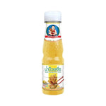 Deksomboon Plum Sauce 175g bottle showing the dark, glossy sauce in a clear glass container for dry grocery use.