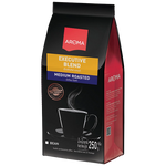 Aroma Coffee Executive Blend drink in a glass with a rich, dark coffee color and a frothy top, served in a clear glass.