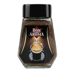 Cup of Bon Aroma Espresso Instant Coffee in a clear glass mug, showing rich, dark coffee with a smooth crema on top.
