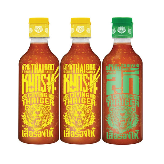 CRYING THAIGER BBQ and Suki Sauce bottles, 490g each, stacked together, showcasing the colorful labels and product packaging.