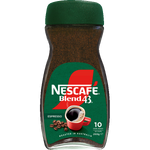 A cup of Nescafe Espresso coffee drink with a rich, dark appearance in a clear glass mug on a neutral background.