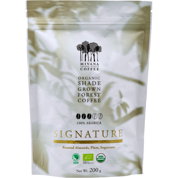 Organic Mivana roasted coffee beans labeled Signature, shown in a close-up image highlighting the rich, dark coffee beans.