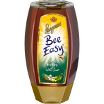 Jar of Langnese Bee Easy Forest Honey with a golden honey drizzling from the jar, showcasing natural honey in a grocery product image.