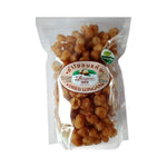 Organic golden dried longan from Thong Poon, showing shiny, plump dried longan fruits in a close-up image.