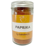 Sainsbury's paprika spice jar with red powdered paprika, labeled for cooking and seasoning in grocery store packaging.