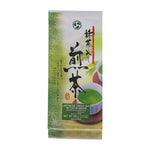 Makotoen Matcha Iri Sencha drink in a glass with frothy green tea, showcasing vibrant green color and fresh tea leaves.
