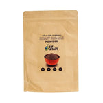 Pure Grain 100% ground roasted black sesame in a 500g package, showing the dark toasted sesame seeds in a dry grocery product image.