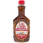 Log Cabin Pancake Syrup bottle with golden syrup flowing out, showing the classic Log Cabin label and a clear glass bottle.