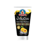 Deksomboon Sweet and Sour Plum Sauce bottle from dry grocery section, featuring clear label and dark plum-colored sauce inside.