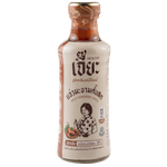 Jar of Jea Spicy Tamarind Sauce in a grocery setting, displaying the label and rich, dark sauce inside the jar.