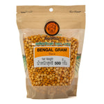 Organic Baboo Bengal Gram (Chana Daal) in a clear bowl, showcasing golden split chickpeas on a white background.