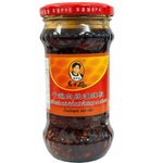 Laoganma Spicy Shredded Pork Chili in a jar, featuring shredded pork and chili peppers, ideal for adding flavor to dishes.