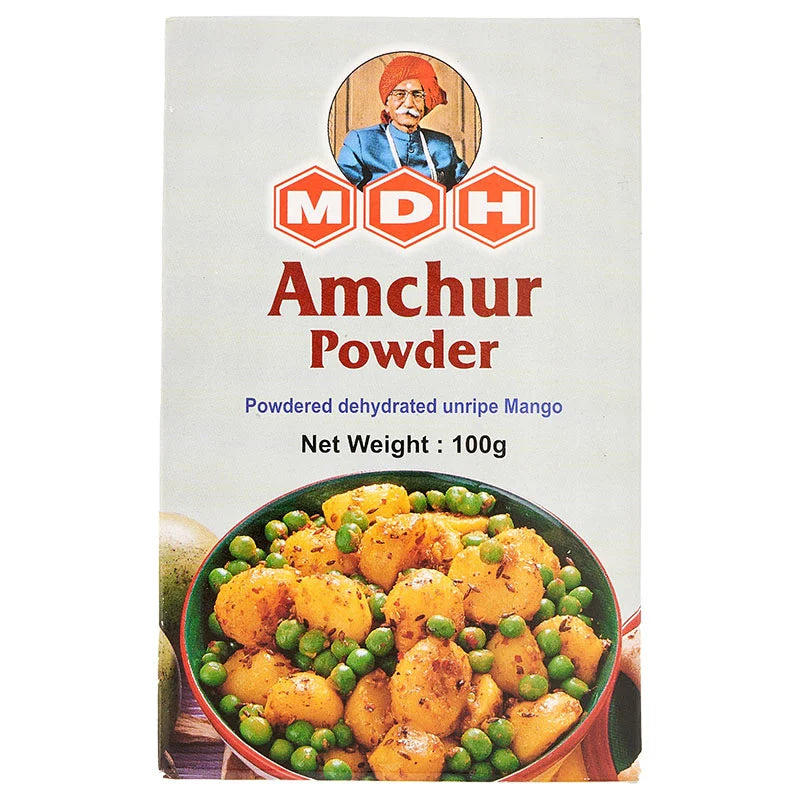 MDH Amchur Powder 100g, bright yellow spice in a clear container, used for tangy flavor in Indian cooking
