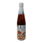 Bottle of Good Life Low Sodium Fish Sauce, a grocery condiment with clear label, sitting on a kitchen countertop.
