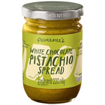 Paweenee's White Chocolate Pistachios in a clear bowl, showing white chocolate-coated pistachios with green nuts inside.