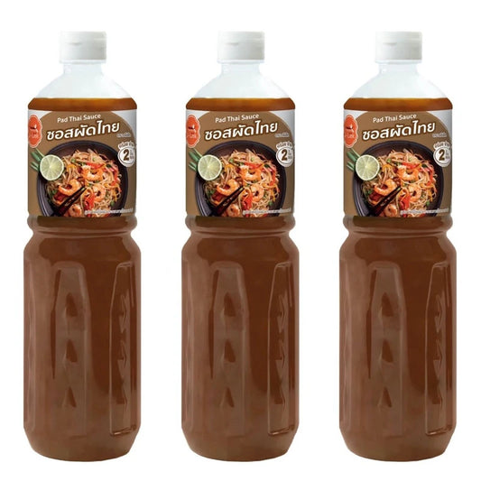 J-LEK Pad Thai Sauce in three 590g bottles, featuring dark soy sauce with a rich, flavorful Thai cooking sauce appearance