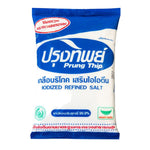 Prung Thip Salt in a clear container, ready for cooking, with a focus on the salt grains and packaging.