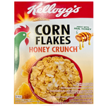 Bowl of Kelloggs Honey Crunch Corn Flakes cereal with honey-glazed flakes and milk in a white bowl on a wooden table