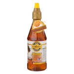 Jar of Pure Grain Wild Flower Honey, natural golden honey from wild flower nectar, in a clear glass jar with a white lid.