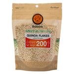 Golden Baboo Quinoa Flakes in a clear bowl, showcasing their light, crunchy texture as a nutritious confectionery snack.