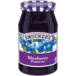 Jar of Smucker's Blueberry Preserves with fresh blueberries and spread on toast, showcasing the fruit preserve's rich texture.