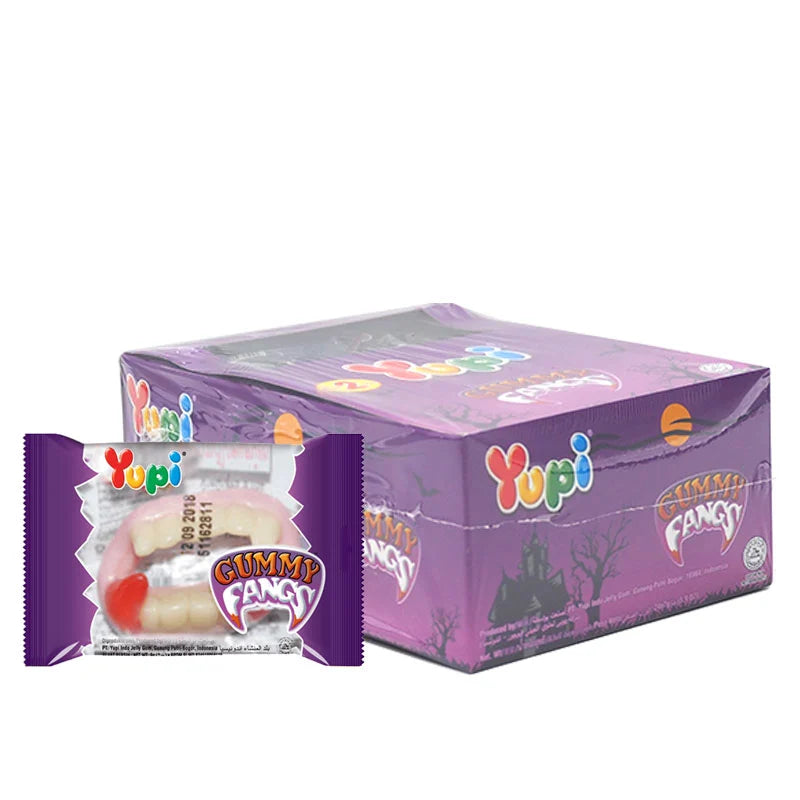YUPI Gummy Fangs 7g pack with colorful, fang-shaped gummies displayed on a white background for fun snack appeal