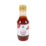 Tutiya Picante Spicy Sauce Jazzy bottle with label, placed on a wooden surface, showcasing the dry grocery spicy sauce product.