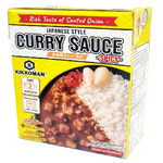 Spicy Kikkoman Japanese Curry Sauce bottle in a grocery store for flavorful Asian cuisine.