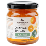 Khaokho Selection Orange Spread jar with orange slices and spread on a wooden surface, showcasing fresh fruit and vibrant color.