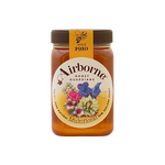 Jar of Airborne Multifloral Honey with a golden color and floral label, showcasing fresh honey in a glass container.