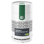 Cup of Northlandtea Organic Assam Black Tea in a glass mug, showcasing rich dark tea with a hint of amber color.
