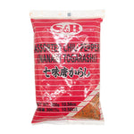 S&B Ichimi Tohgarashi 300g dry red chili pepper flakes in a clear plastic container, showcasing vibrant red chili powder.