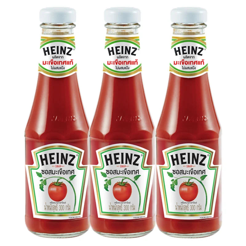 Three bottles of HEINZ Tomato Sauce, 300g each, with red caps and labels, arranged side by side.