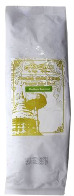 Aroma Viengping Medium drink in a clear glass bottle with a label, showcasing the beverage's golden color and branding.