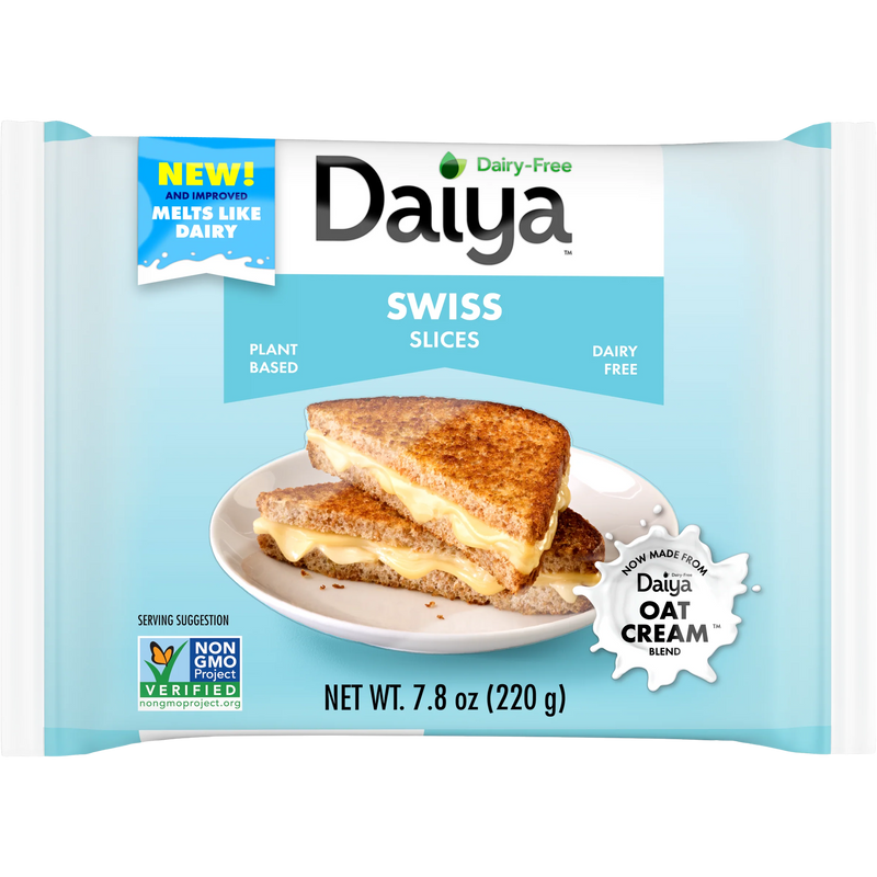 Daiya vegan Swiss cheese slices stacked on a plate, showcasing their creamy texture and plant-based ingredients.