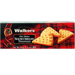 Walkers Butter Shortbread Triangles, delicious confectionery snacks with buttery flavor and crisp texture, arranged on a white plate.
