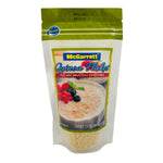 Mcgarrett Quinoa Flakes 150g in a clear package, showing light, flaky quinoa cereal ready for breakfast or cooking.