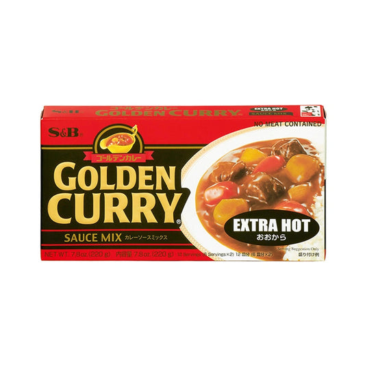 S&B Golden Curry Extra Hot 220g packet with vibrant yellow packaging and curry powder spilling out on a wooden surface.