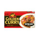 S&B Golden Curry Extra Hot 220g packet with vibrant yellow packaging and curry powder spilling out on a wooden surface.