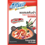 Bottle of Fa Thai Tom Yum Sauce, a Thai grocery item, with red chili, herbs, and garlic visible in the sauce label.