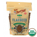 Organic brown flaxseeds in a clear glass jar, displayed as a healthy grocery product from Bob's Red Mill.