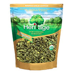 Heritage Organic Raw Pumpkin Seeds 454g in a clear bowl, showing light green and tan pumpkin seeds for healthy snacking or cooking.
